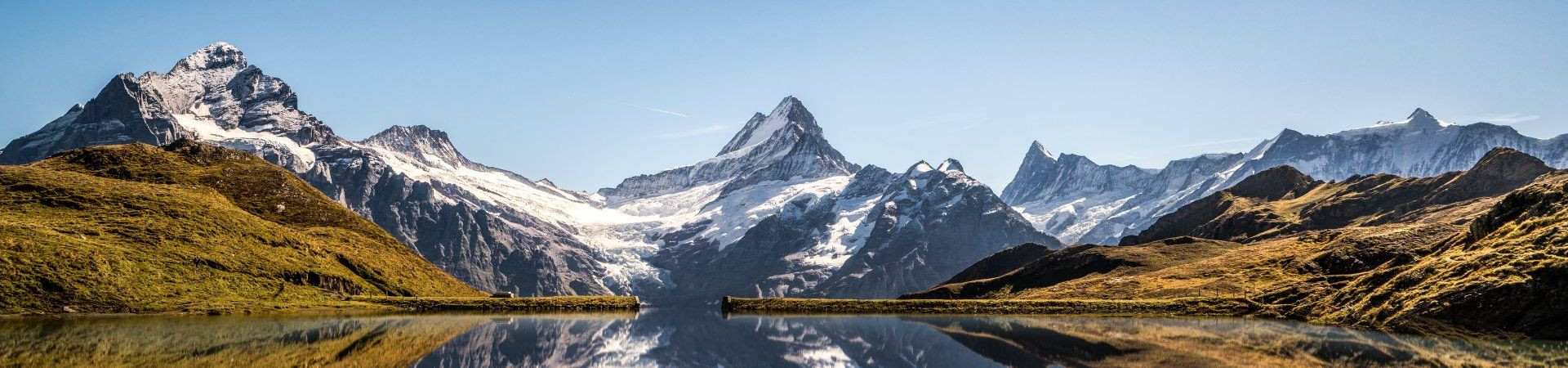 Mountain lake reflecting snow-capped peaks - Bernese Oberland - Switzerland