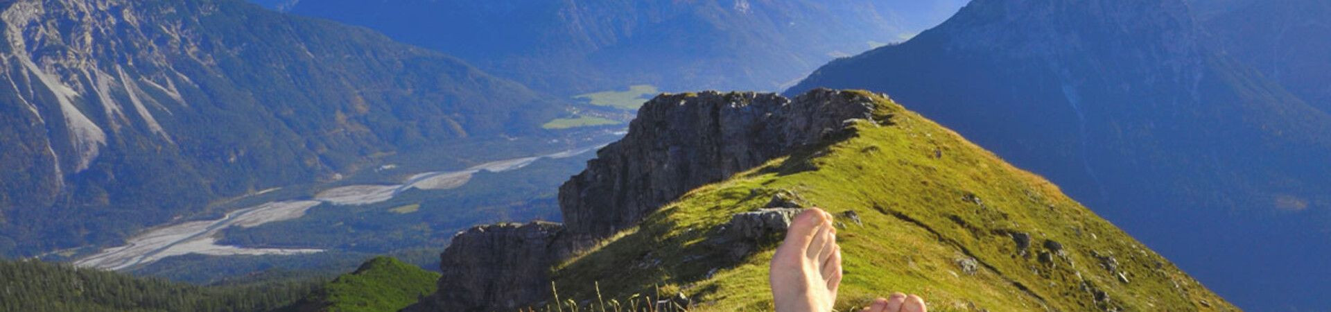Barefoot rest on a ridge facing the peaks - Alps
