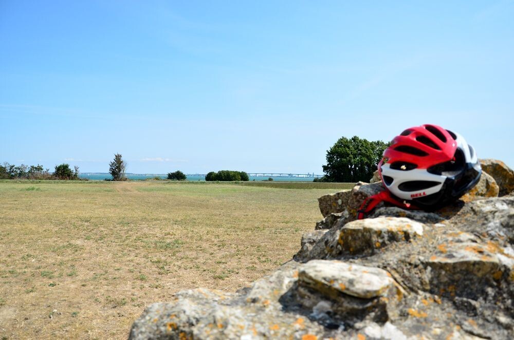 Cycling helmet with the Île de Ré bridge in the distance