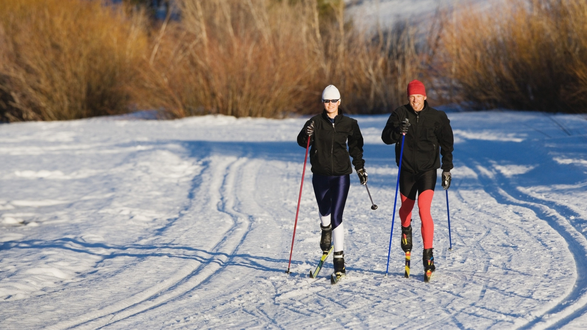Two cross-country skiers on a groomed trail - nordic skiing
