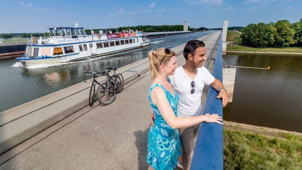 © Andreas Lander Cycling couple on the water bridge - Magdeburg - Germany