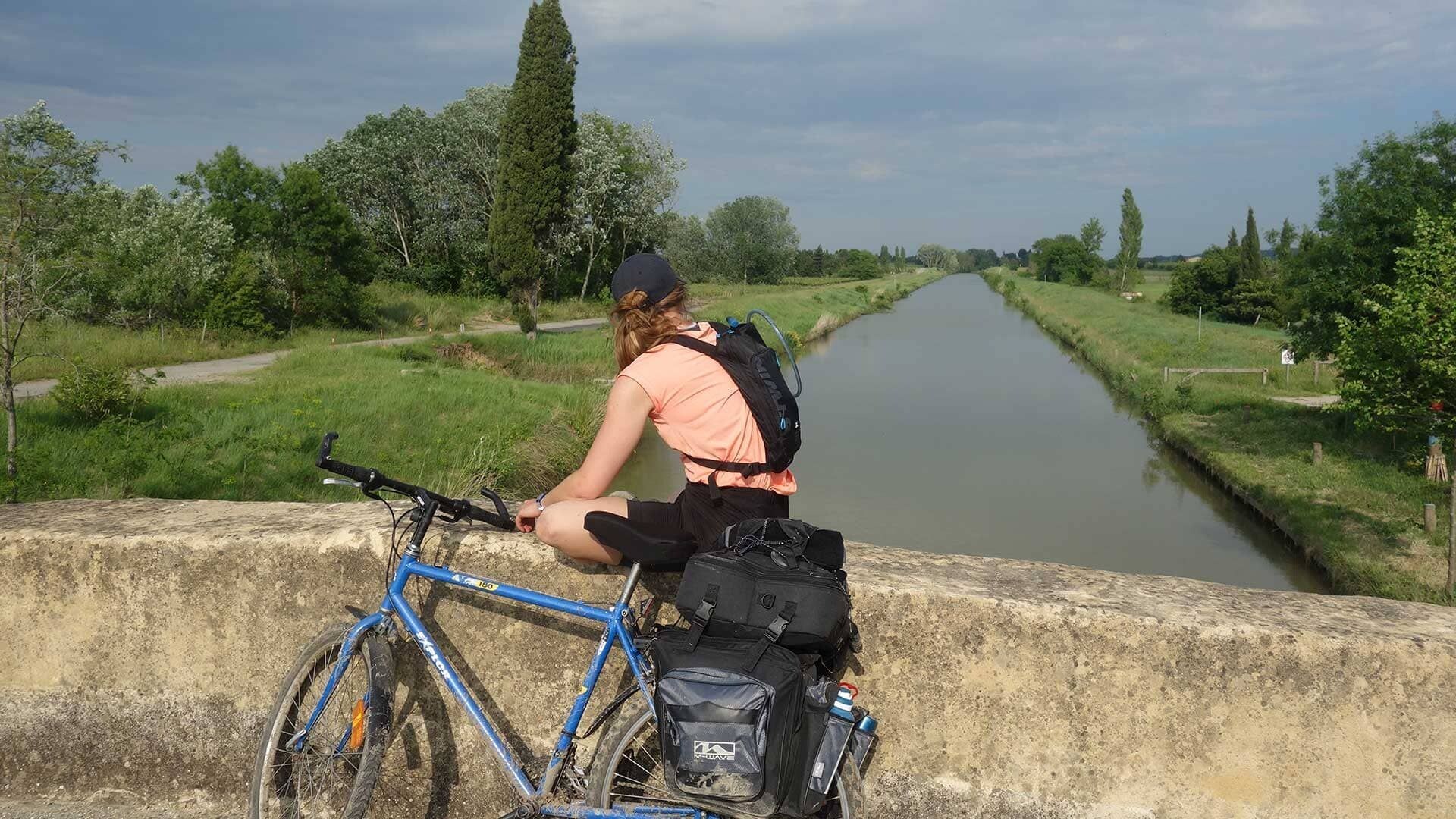 Cyclist on a bridge over the canal - Canal du Midi - Occitanie - France