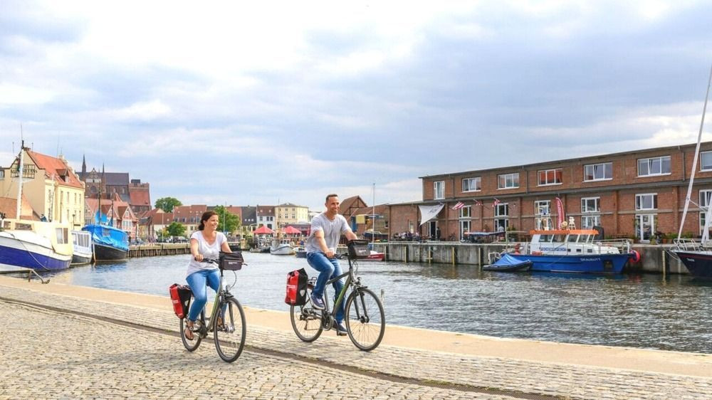 Cyclists on the old harbour quay - Wismar - Germany
