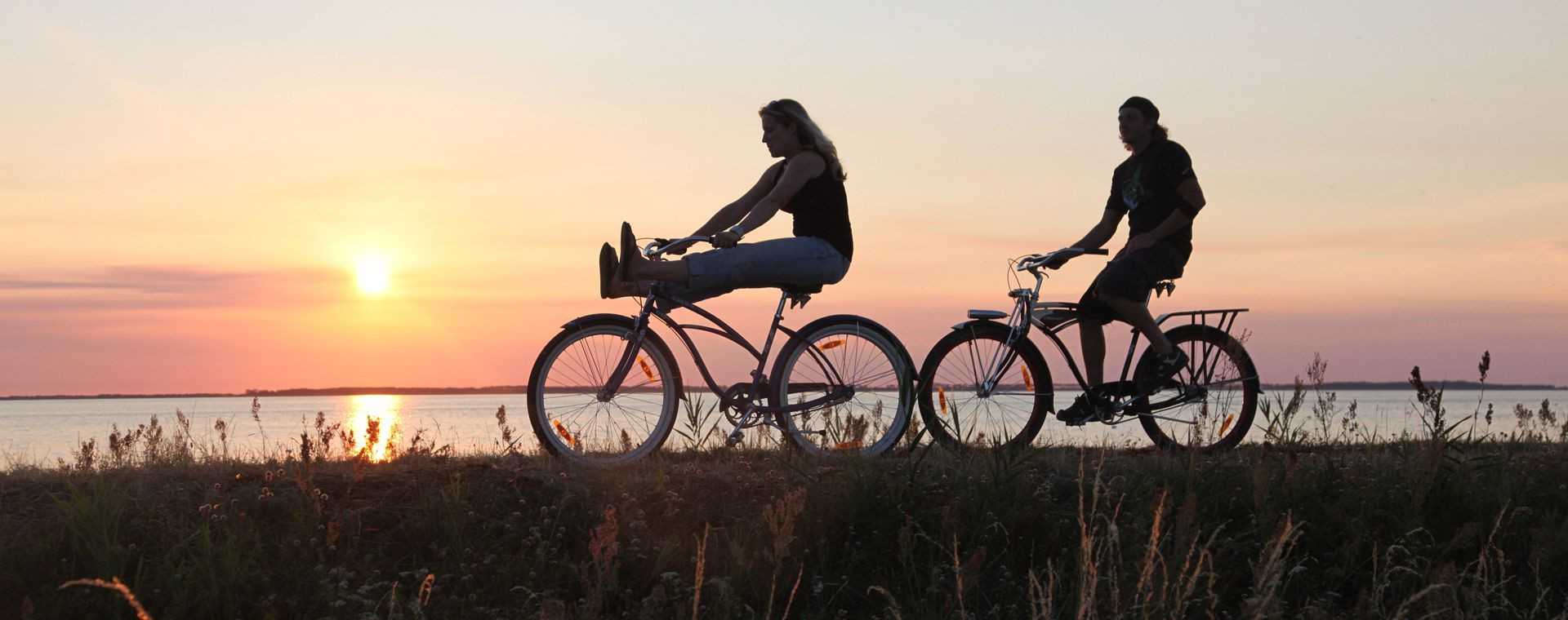 Cyclists at sunset along the waterside - Ummanz Island - Germany
