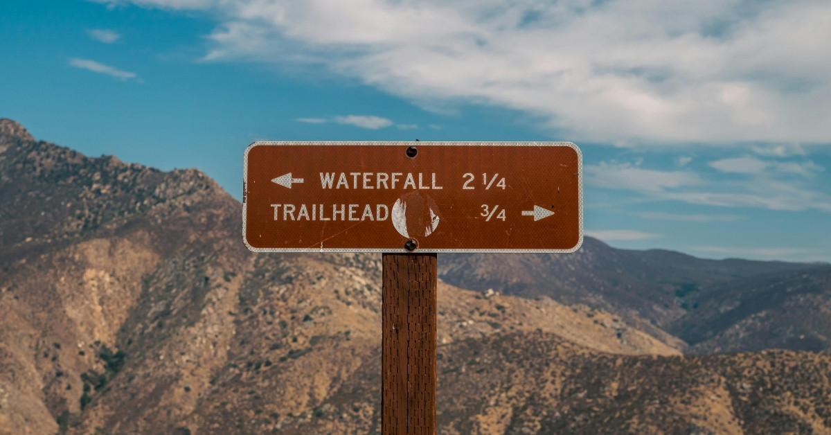 Directional hiking sign in arid mountains