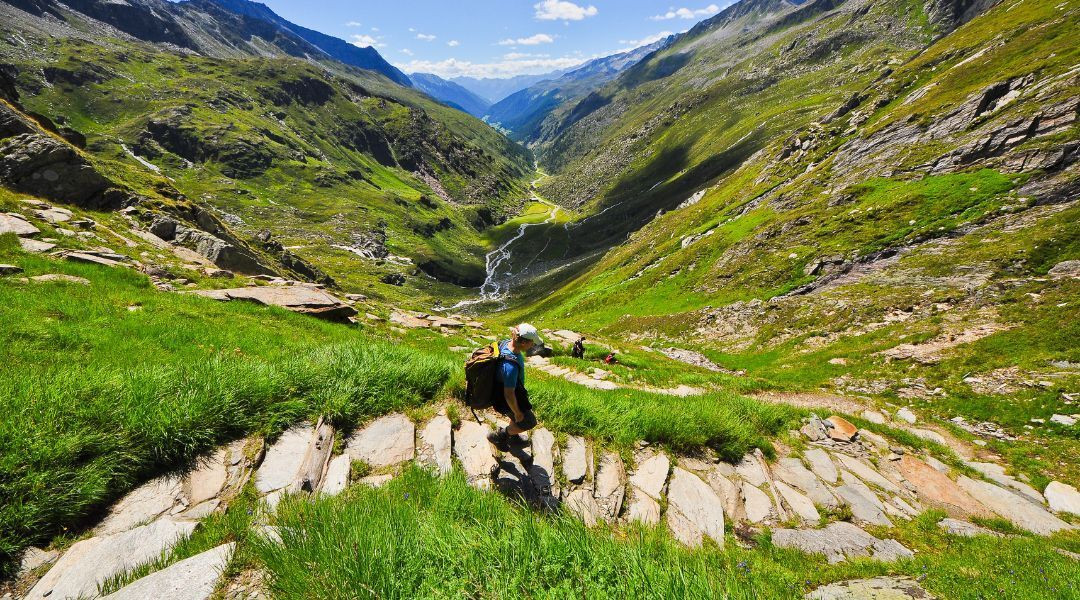 Female hiker contemplating mountains on a self-guided trip