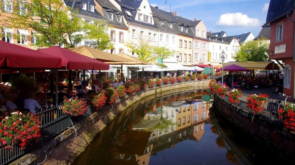 Flower-lined canal and terraces in the old town of Saarburg - Saar - Germany