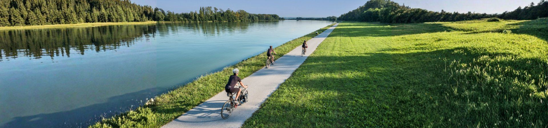 Cyclists on a path along a canal - Bavaria - Germany