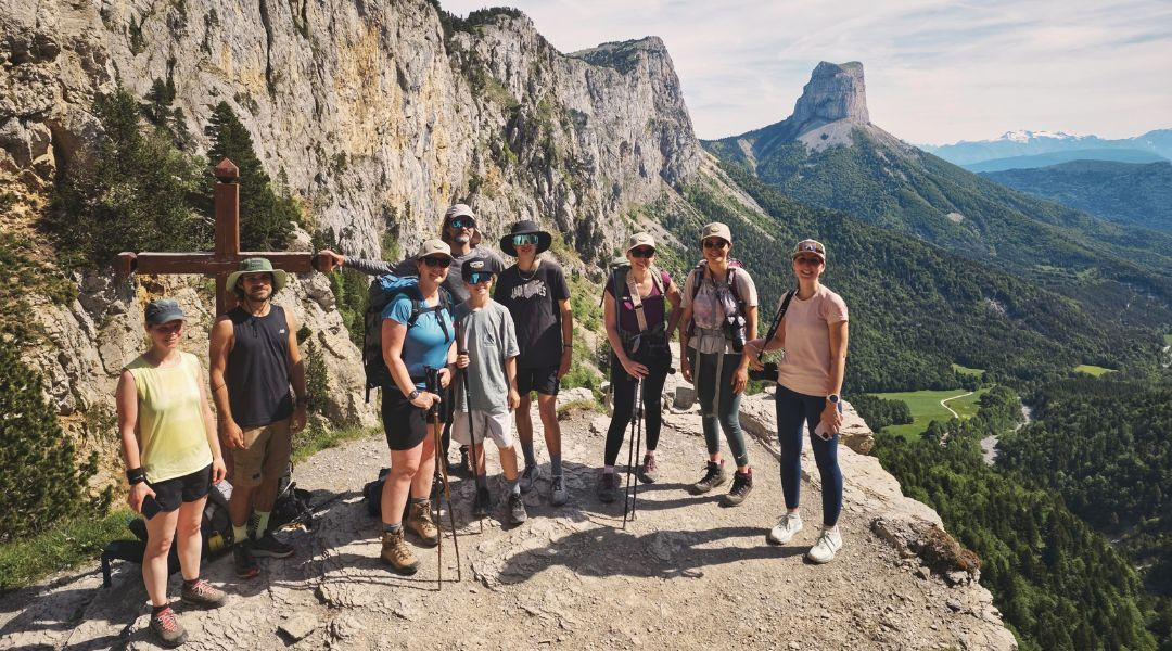 Hikers at a cross facing Mont Aiguille - Vercors - France