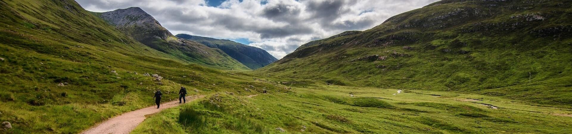 Hikers in a green glen - Highlands - Scotland