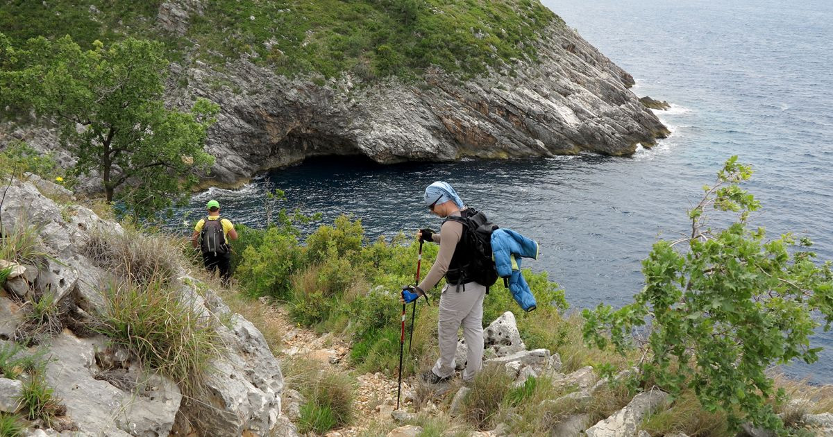 Hikers on coastal trail near Grama beach - Albania