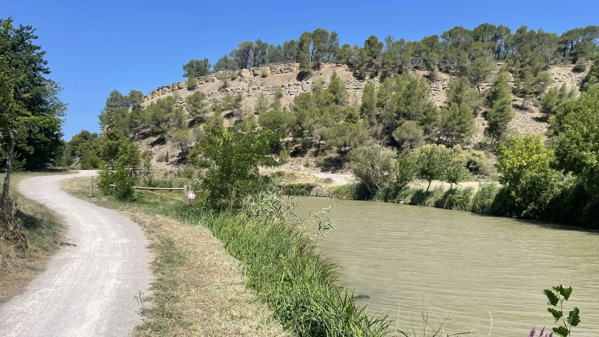 Towpath along a canal below a hillside - Canal du Midi - France