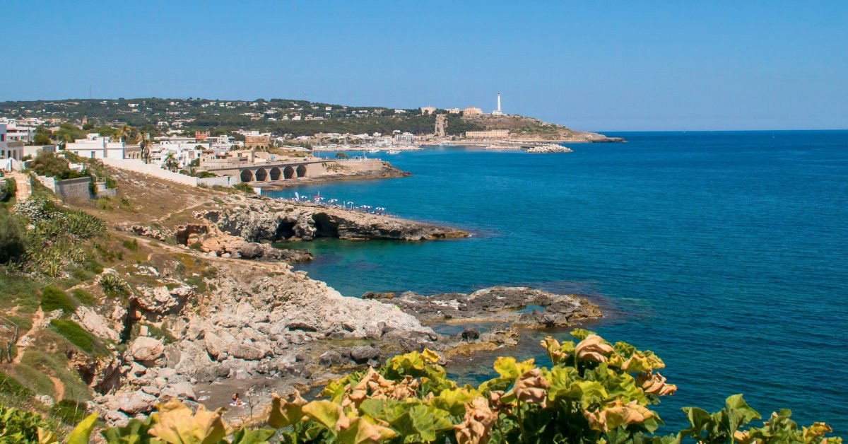 Lighthouse and sunlit rocky coast - Santa Maria di Leuca - Puglia - Italy