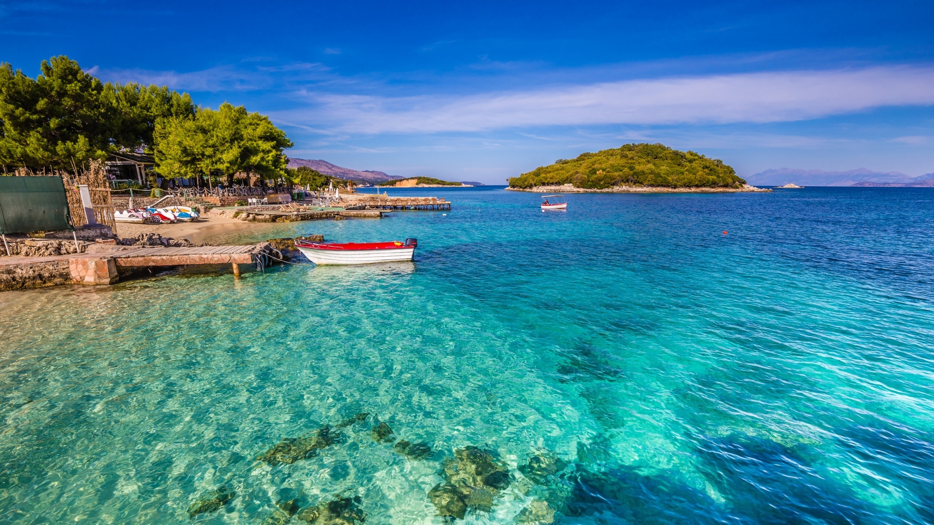 Turquoise cove with a small boat - Ksamil - Albanian Riviera - Albania