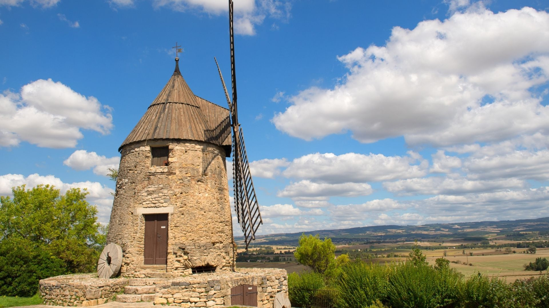Stone Cugarel windmill under a cloudy sky - Castelnaudary - Aude, France