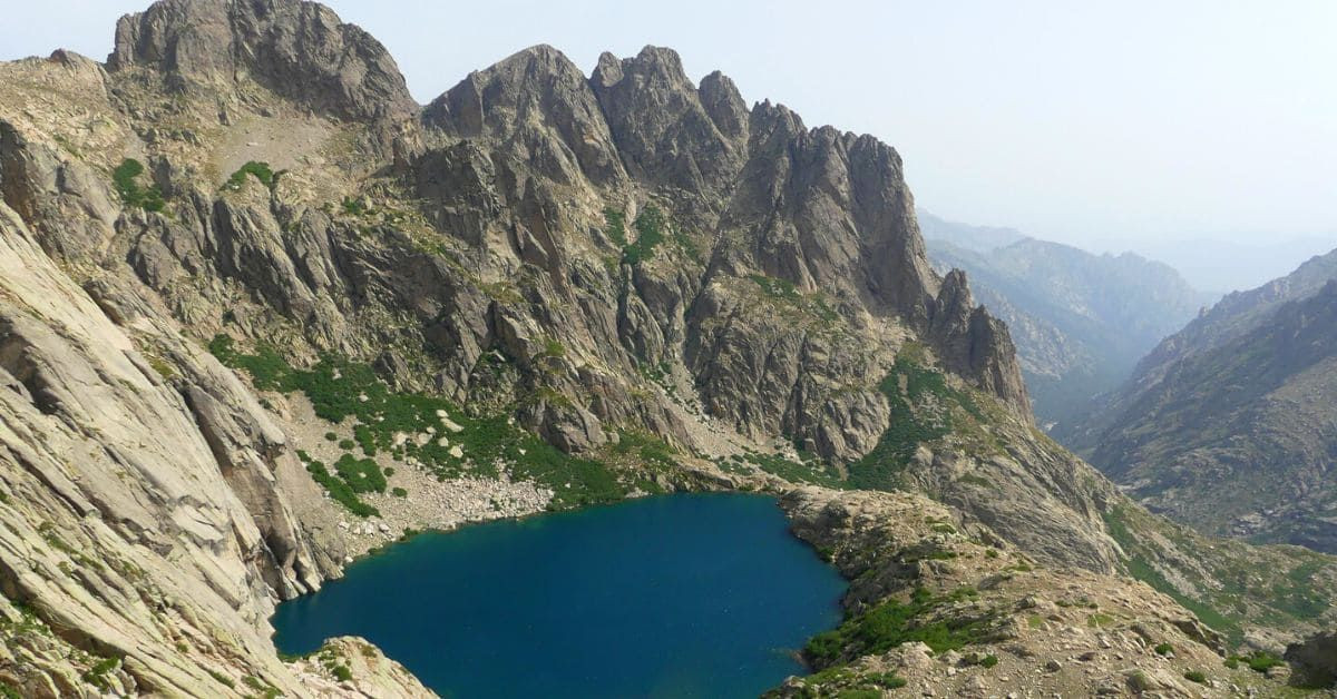 Mountain lake below granite peaks - Corsica - France
