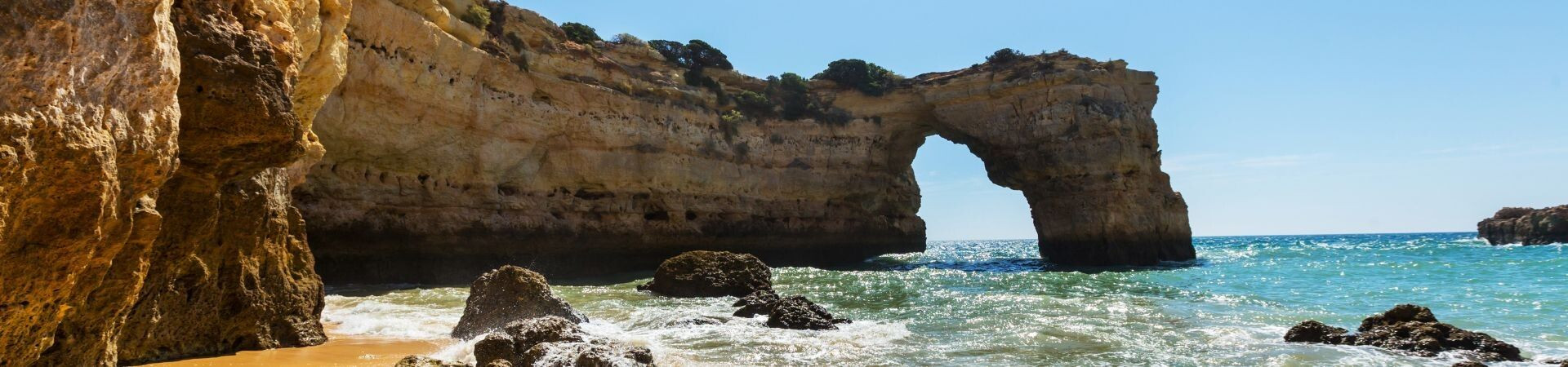 Natural rock arch on a beach - Algarve coast - Portugal