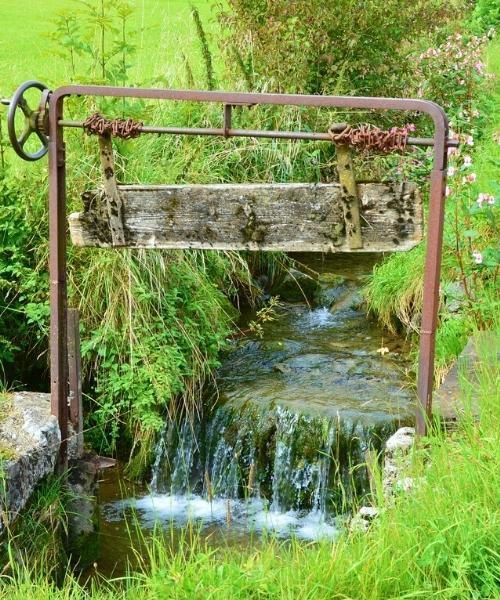 Old water sluice gate over a mountain stream