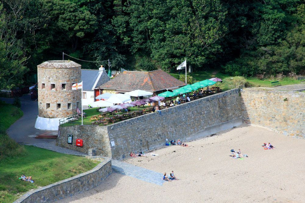 Petit Bôt Bay on the south coast – its café, beach and Martello tower © François Ribard