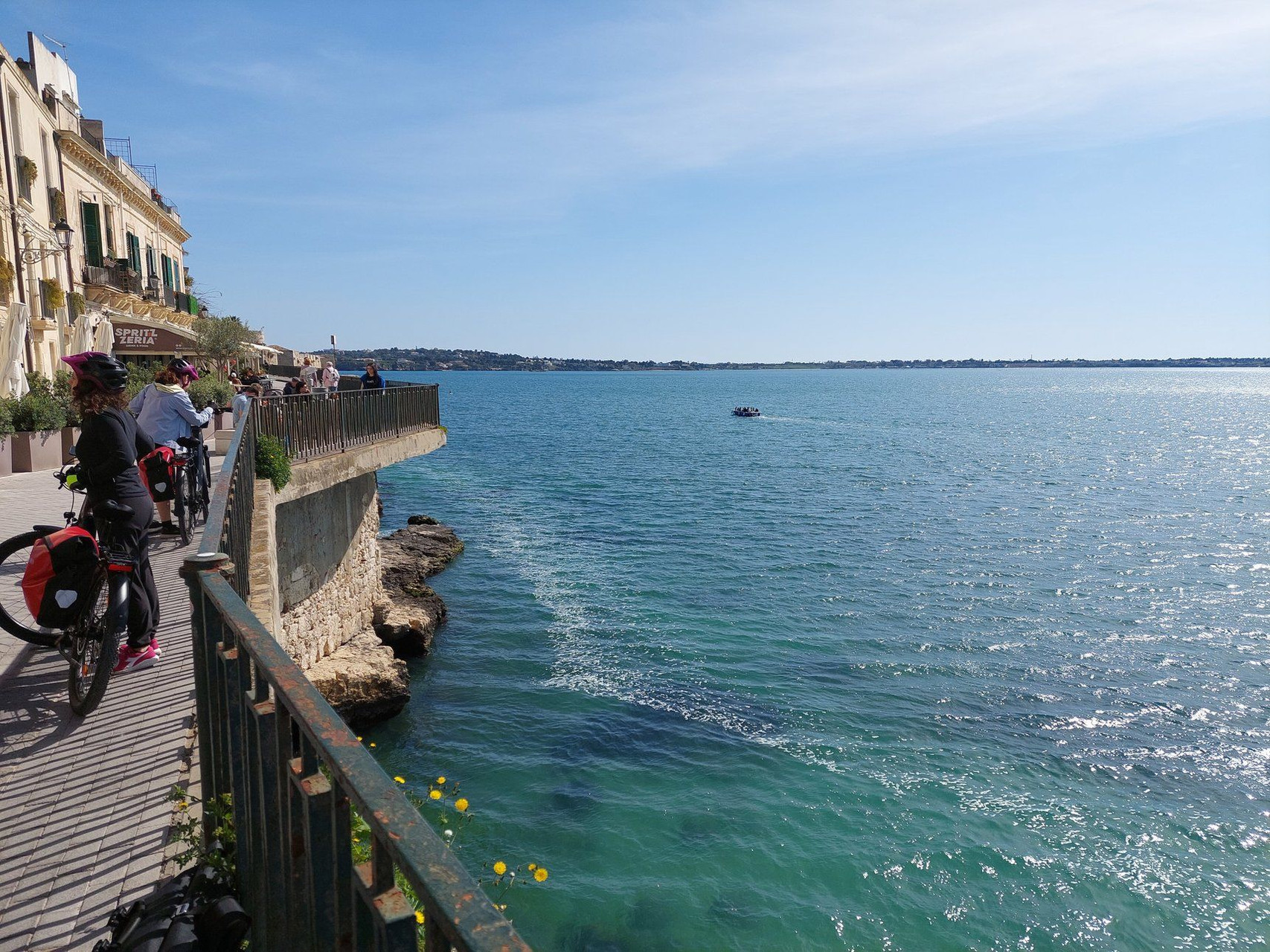 Cyclists on the Ortigia seafront - Syracuse - Sicily - Italy