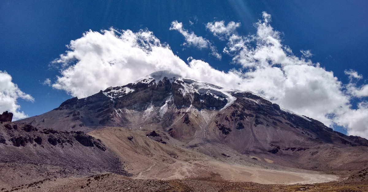 Snow-capped volcano and arid highland landscape - Bolivia