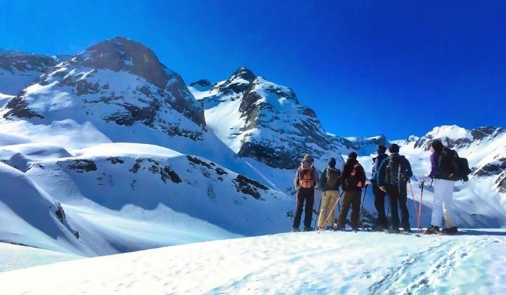 Snowshoers facing snowy peaks - Eastern Pyrenees - France