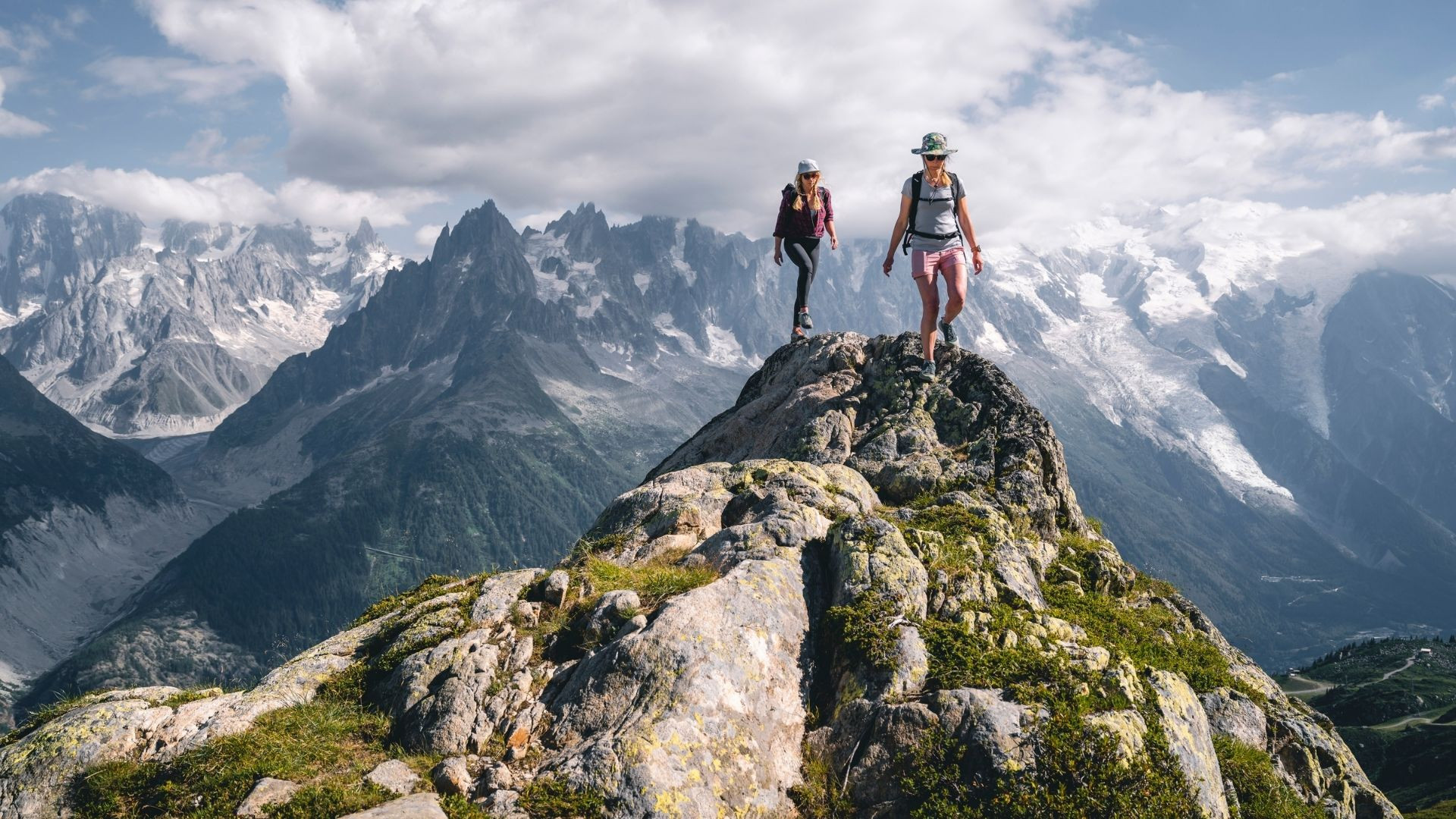 Two hikers on a ridge facing the Mont Blanc massif - Alps - France