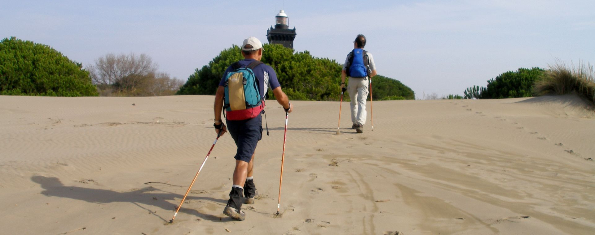 Nordic walking toward the lighthouse on the dunes - Camargue - France