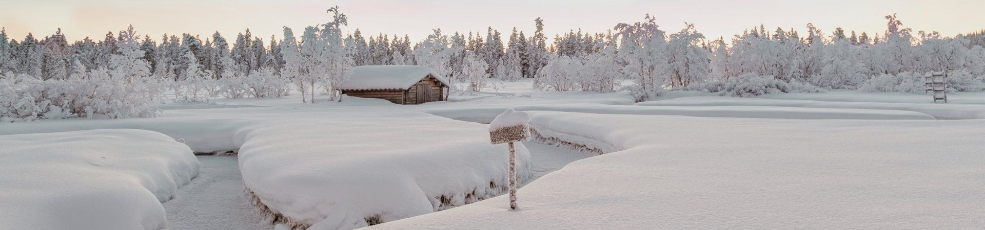 Wooden cabin in a snowy winter landscape - Lapland